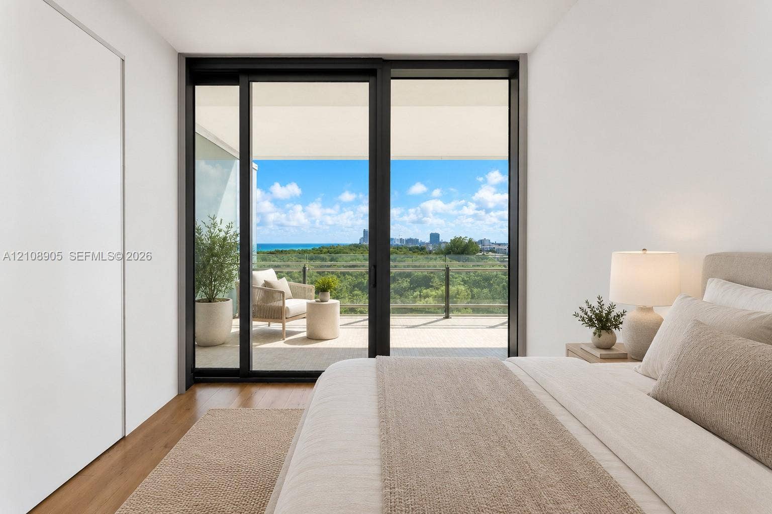 Floor-to-ceiling sliding glass door, wood-finish flooring, and private balcony with glass railing