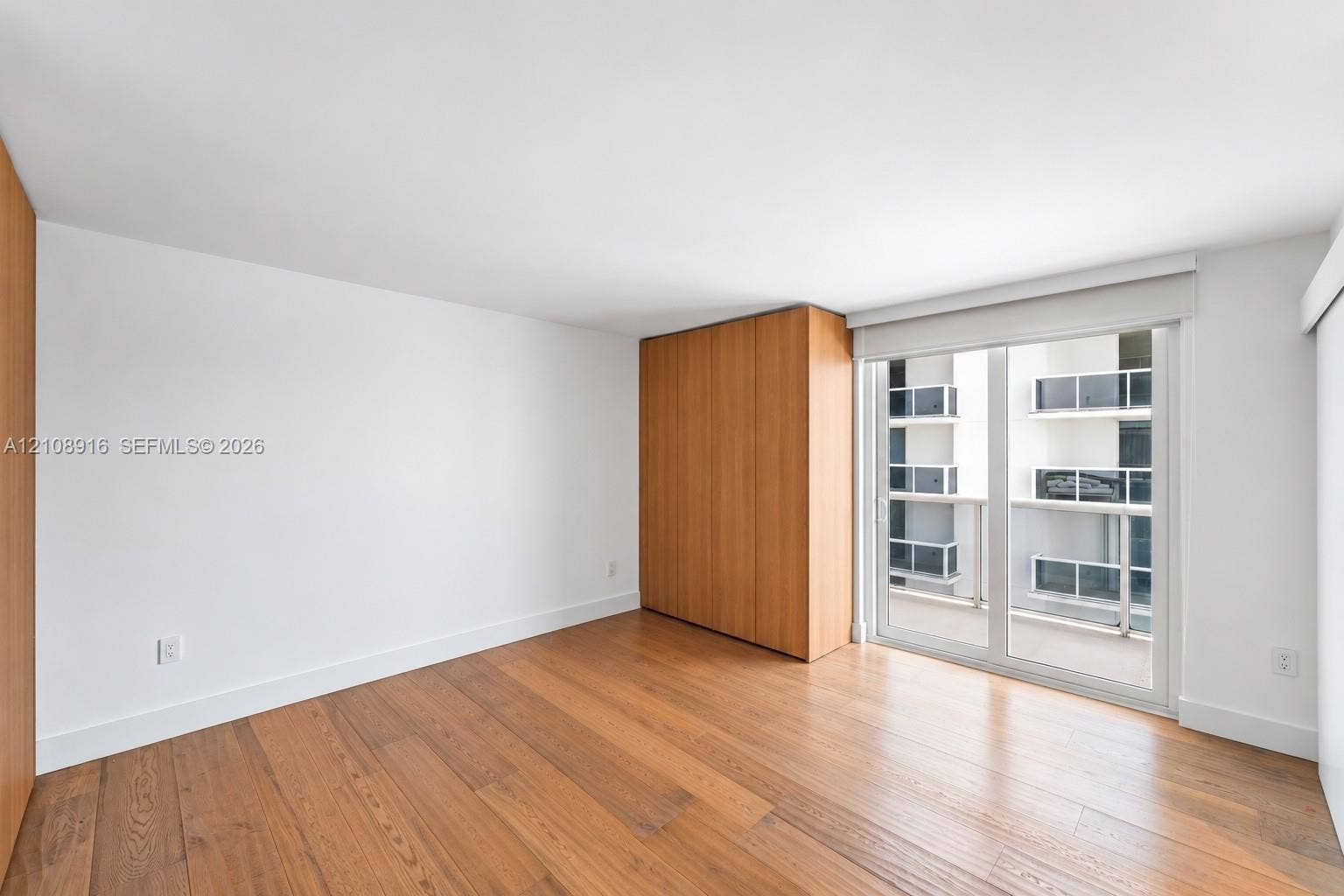 Master bedroom featuring newly installed hurricane proof sliding doors to private balcony with city and bayviews