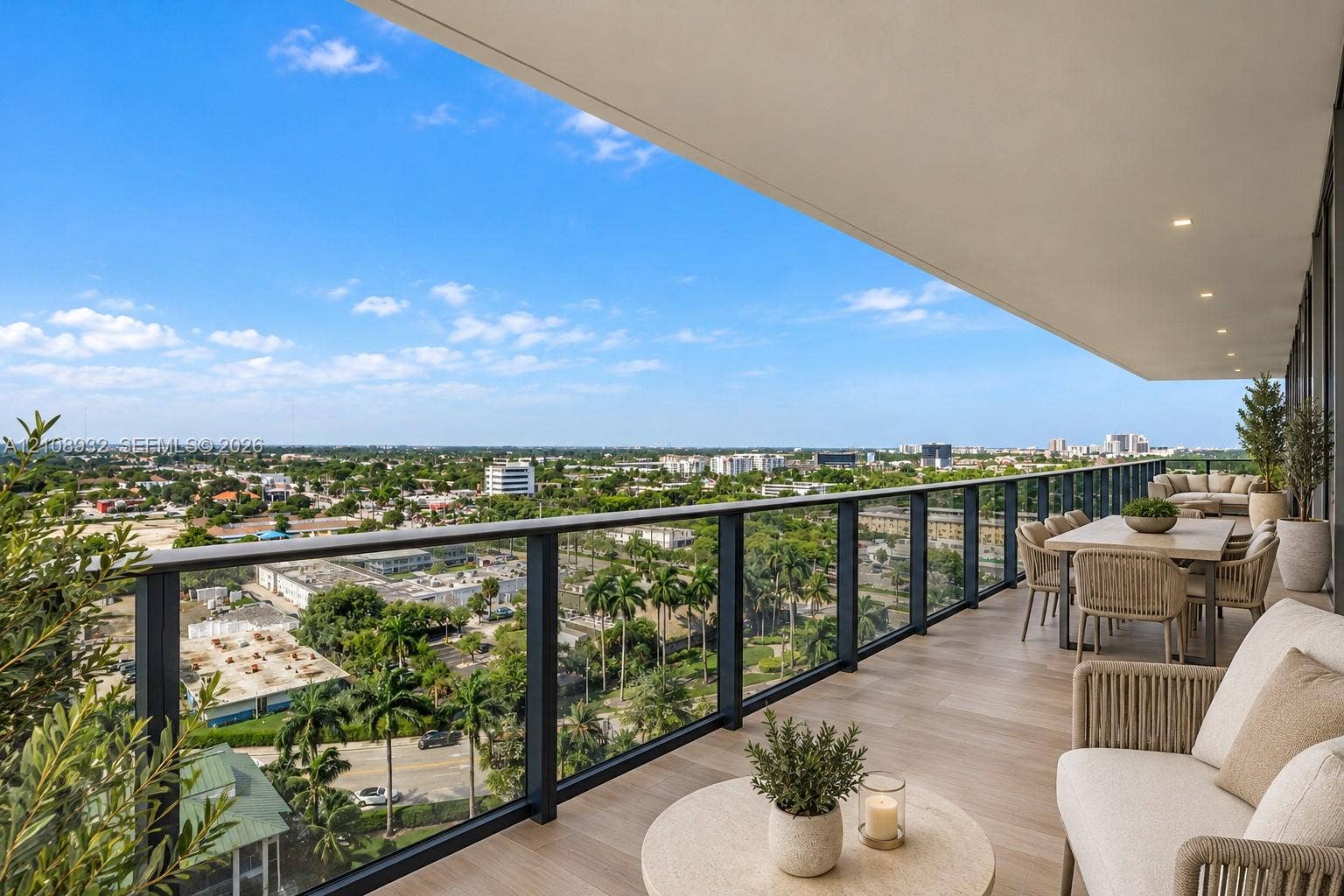 1170 E Hallandale Beach Boulevard, #1201, Hallandale Beach, FL 33009 Expansive covered balcony featuring wood-finish flooring, recessed lighting, and a modern glass and metal railing system