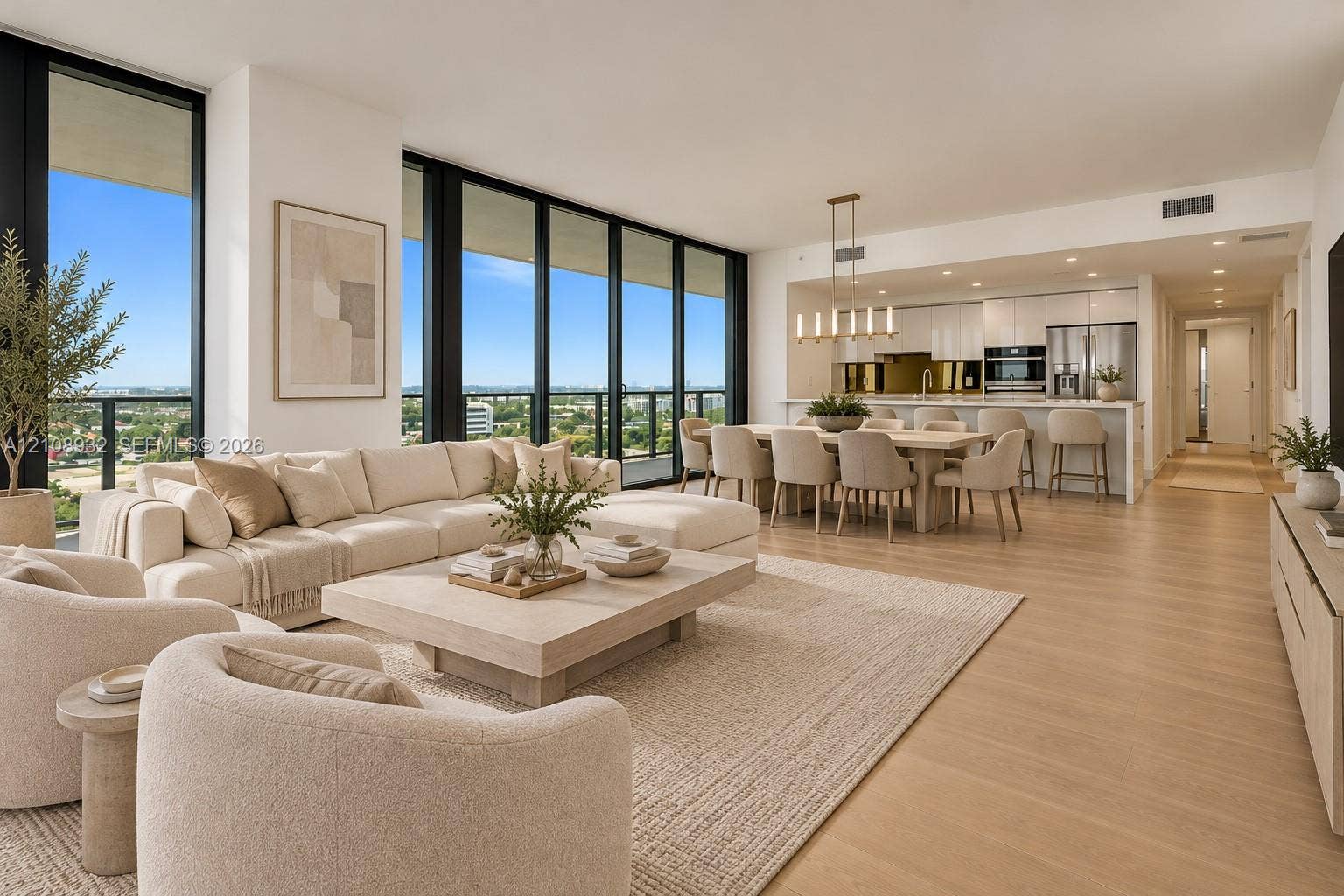 1170 E Hallandale Beach Boulevard, #1201, Hallandale Beach, FL 33009 Open-concept living space featuring floor-to-ceiling windows, wood-finish flooring, recessed lighting, and a modern kitchen with built-in stainless steel appliances