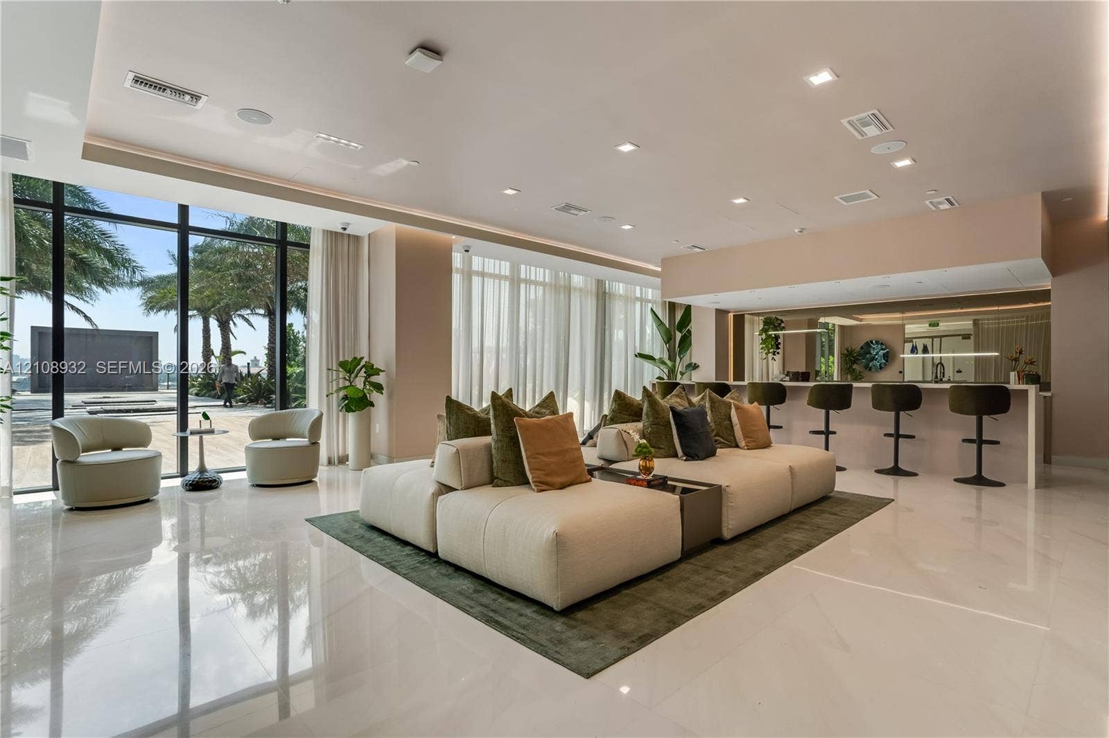 1170 E Hallandale Beach Boulevard, #1201, Hallandale Beach, FL 33009 Open-concept interior featuring floor-to-ceiling windows, polished stone flooring, recessed ceiling lighting, and a built-in bar area with stone countertops