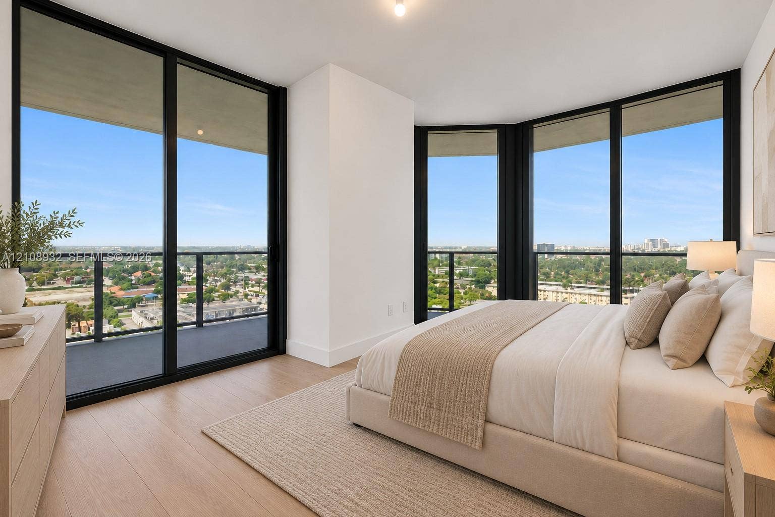 1170 E Hallandale Beach Boulevard, #1201, Hallandale Beach, FL 33009 Floor-to-ceiling windows, wood-finish flooring, and an expansive wraparound balcony with metal railings