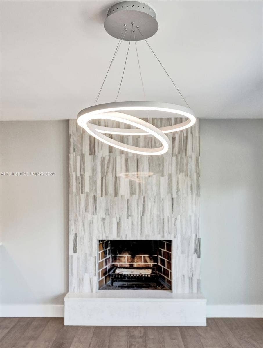 525 SW 12th Street, Fort Lauderdale, Fort Lauderdale, FL 33315 Contemporary circular pendant lighting, full-height vertical stone tile fireplace surround, exposed brick firebox, and solid stone hearth