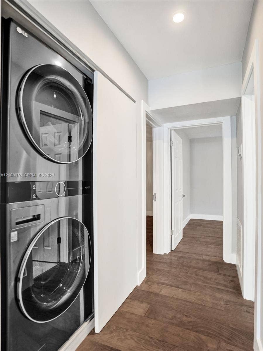 525 SW 12th Street, Fort Lauderdale, Fort Lauderdale, FL 33315 Laundry area featuring a stackable stainless steel appliance unit, recessed lighting, and wood-finish flooring