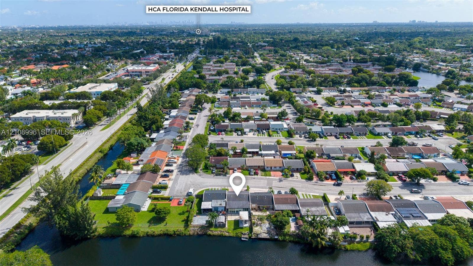 4252 SW 131st Avenue, Miami, FL 33175 Aerial perspective of a residential property featuring a direct waterfront lot, private lawn area, and paved off-street parking
