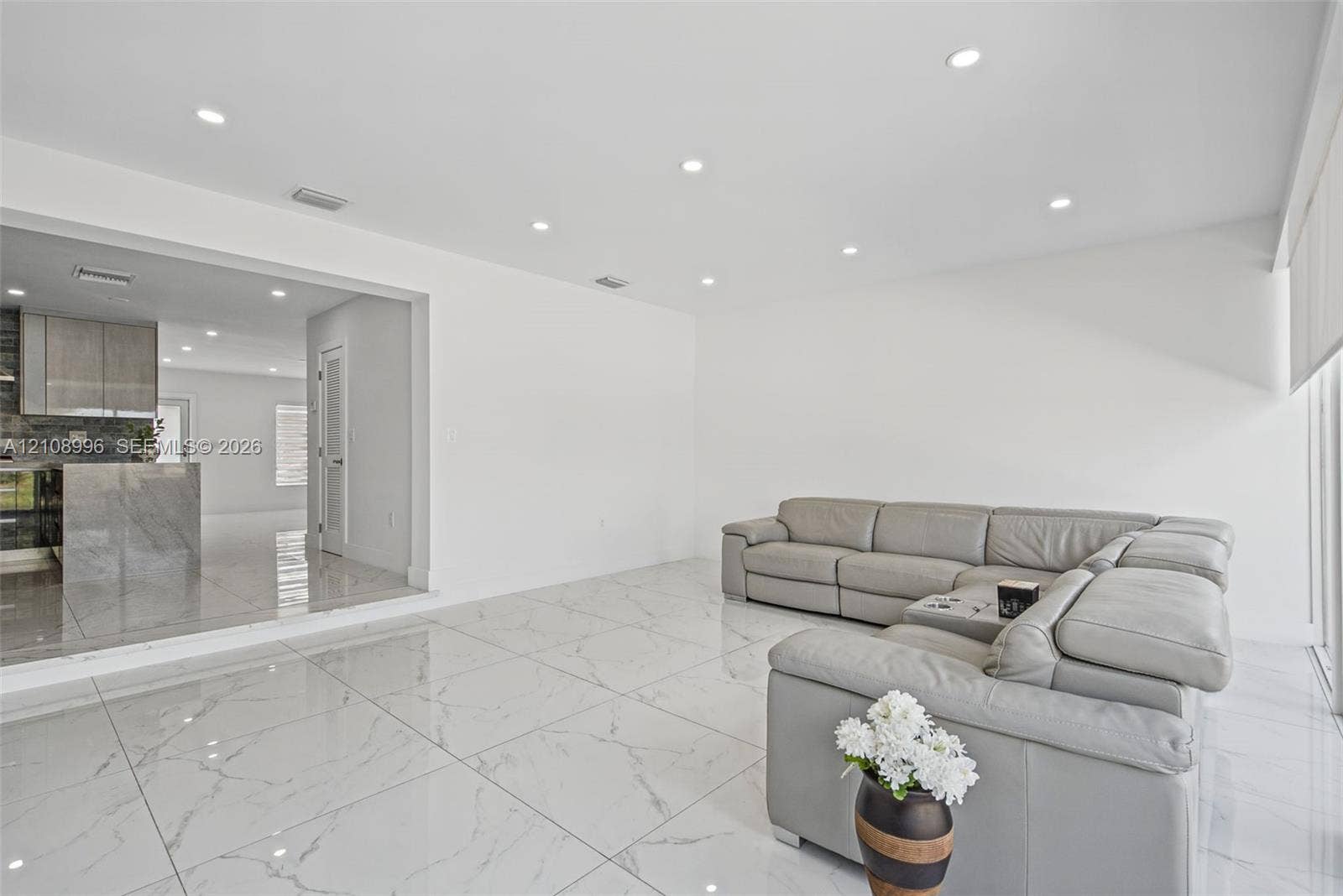 4252 SW 131st Avenue, Miami, FL 33175 Large-format stone-patterned tile flooring, recessed ceiling lighting, and smooth-finish walls