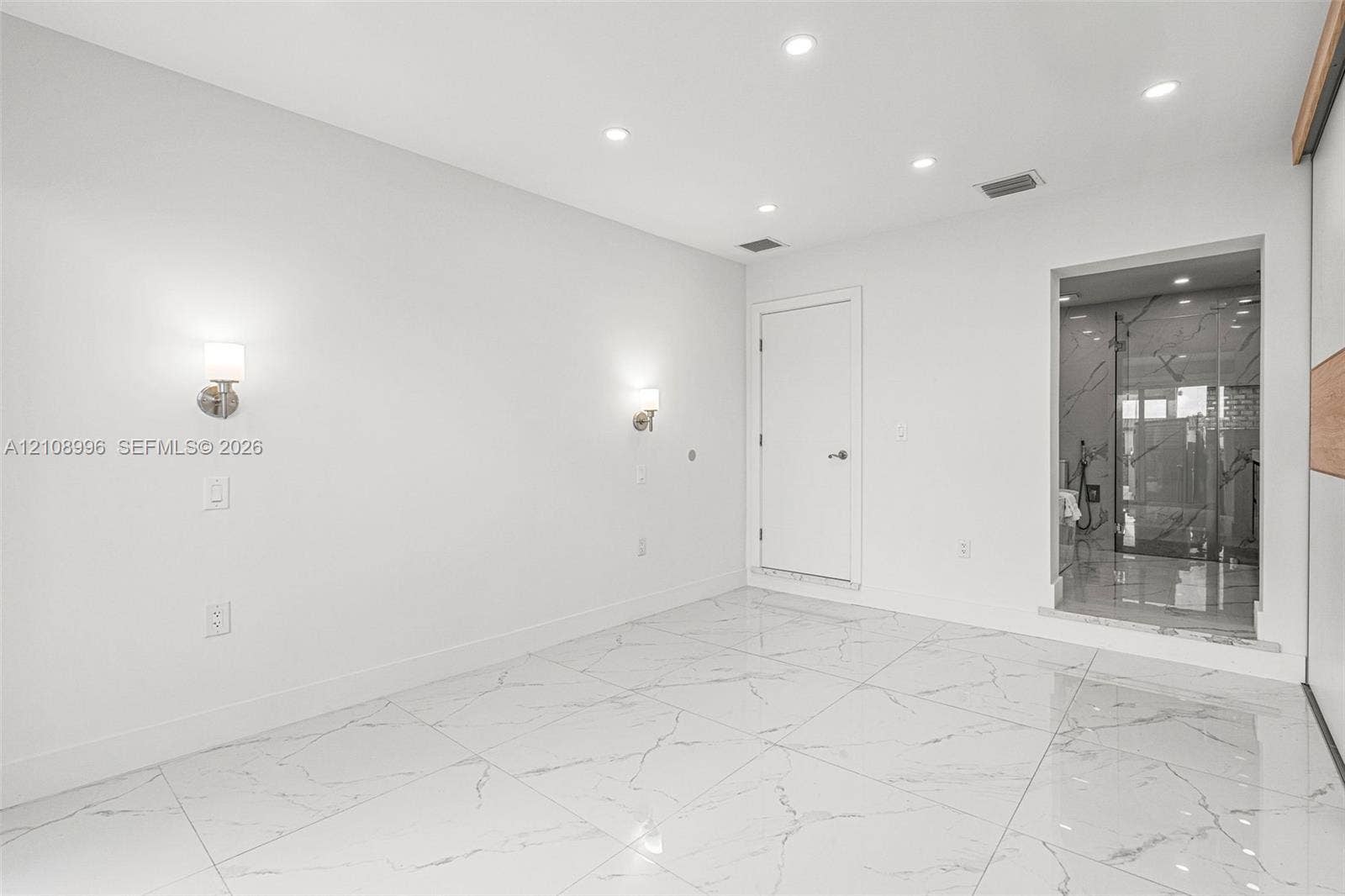 4252 SW 131st Avenue, Miami, FL 33175 Large-format tile flooring with veined detailing, recessed ceiling lighting, and dual wall-mounted light fixtures