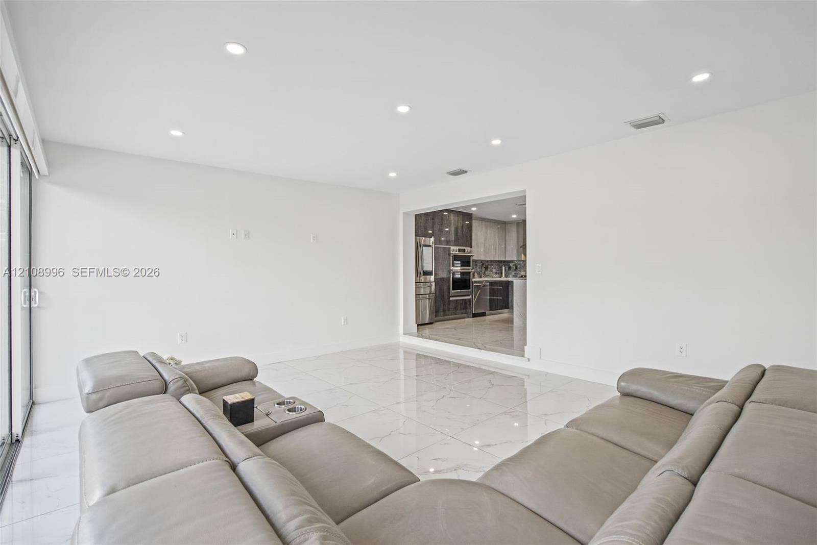 4252 SW 131st Avenue, Miami, FL 33175 Polished stone-finish flooring, recessed lighting, and large sliding glass door