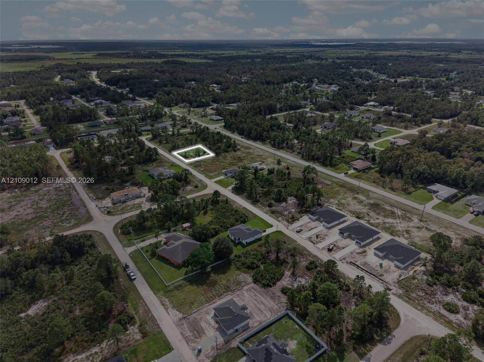 846 Burns Avenue S, Lehigh Acres, Lehigh Acres, FL 33974 Aerial perspective of a corner lot featuring level topography, native vegetation, and surrounding paved roadways