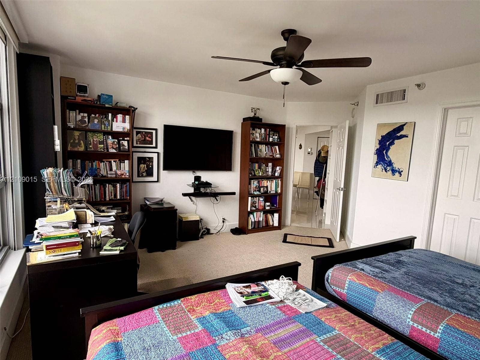 3530 Mystic Pointe Drive, #1709, Aventura, FL 33180 Spacious interior featuring neutral carpeting, a central ceiling fan with integrated lighting, and multiple paneled interior doors