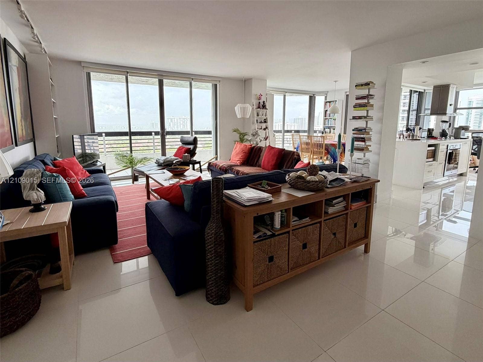 3530 Mystic Pointe Drive, #1709, Aventura, FL 33180 Open-concept interior featuring large-format tile flooring, floor-to-ceiling glass sliding doors, and recessed lighting