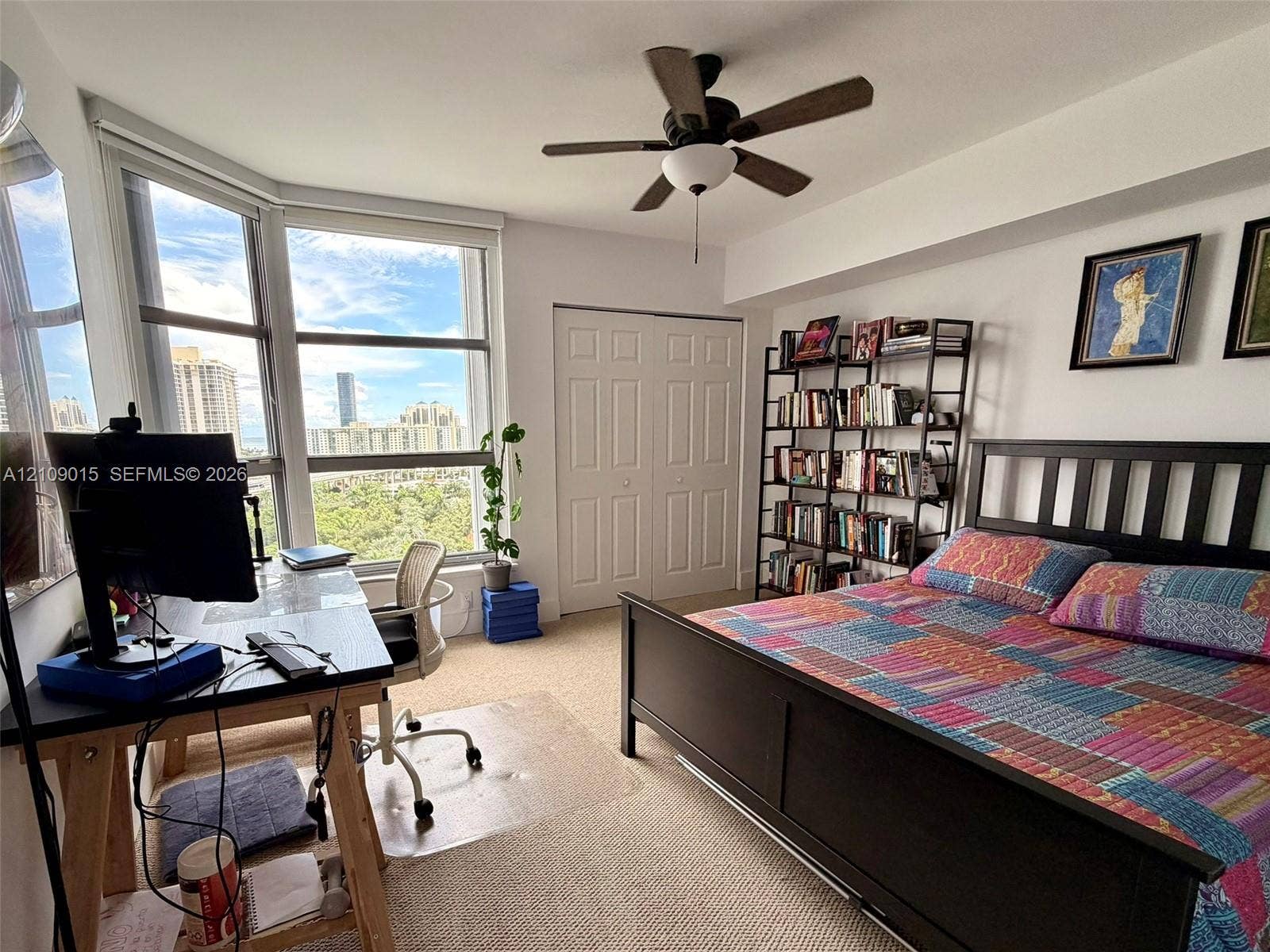 3530 Mystic Pointe Drive, #1709, Aventura, FL 33180 Expansive bay windows, neutral carpeting, ceiling fan with integrated lighting, and a double-door closet
