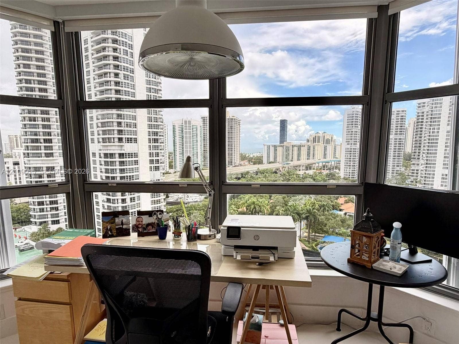 3530 Mystic Pointe Drive, #1709, Aventura, FL 33180 Floor-to-ceiling windows featuring panoramic urban scenery and a dome pendant light fixture