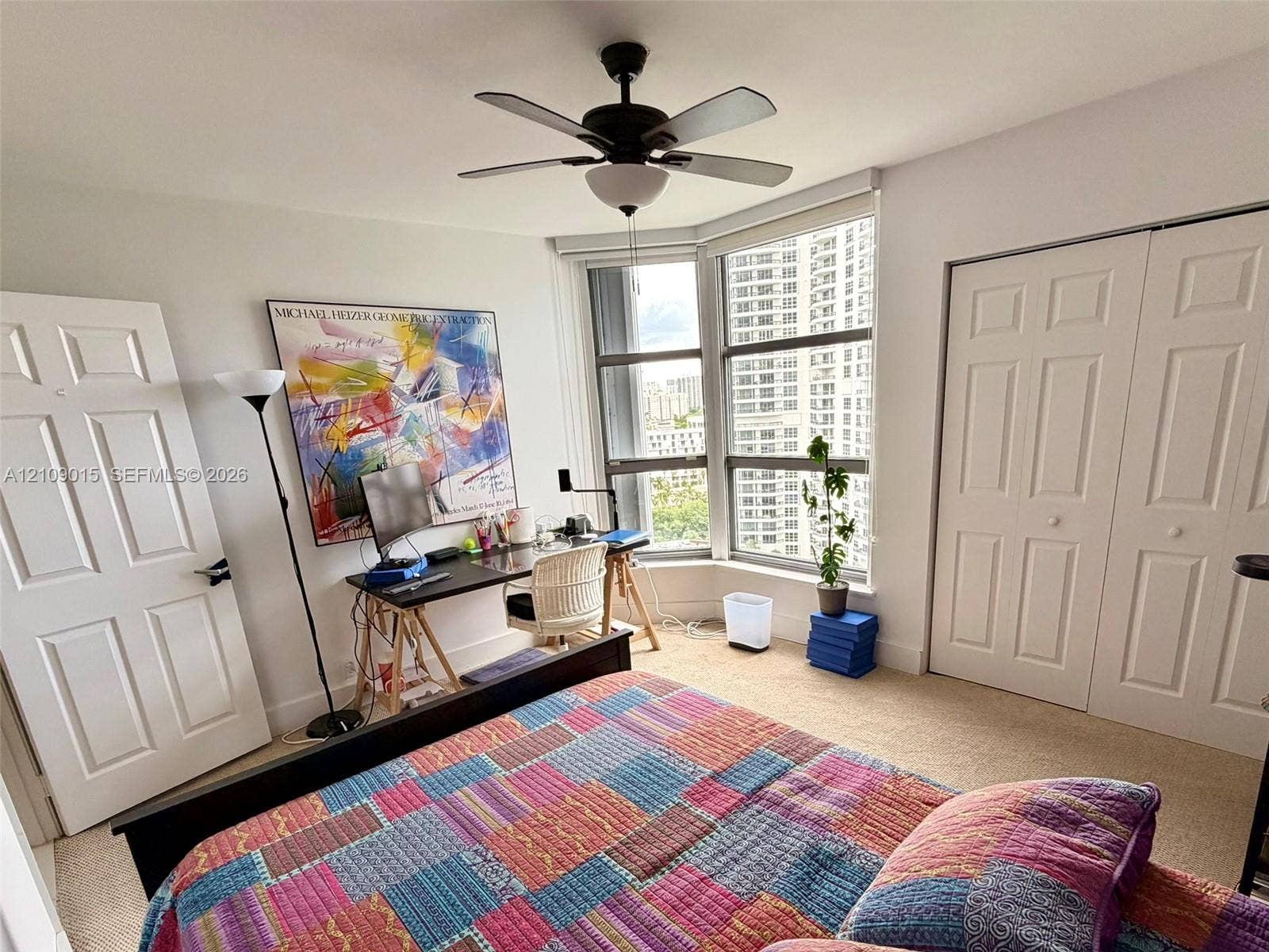 3530 Mystic Pointe Drive, #1709, Aventura, FL 33180 Bay window with floor-to-ceiling glass, neutral carpeting, ceiling fan with integrated light fixture, and white dual-panel closet doors