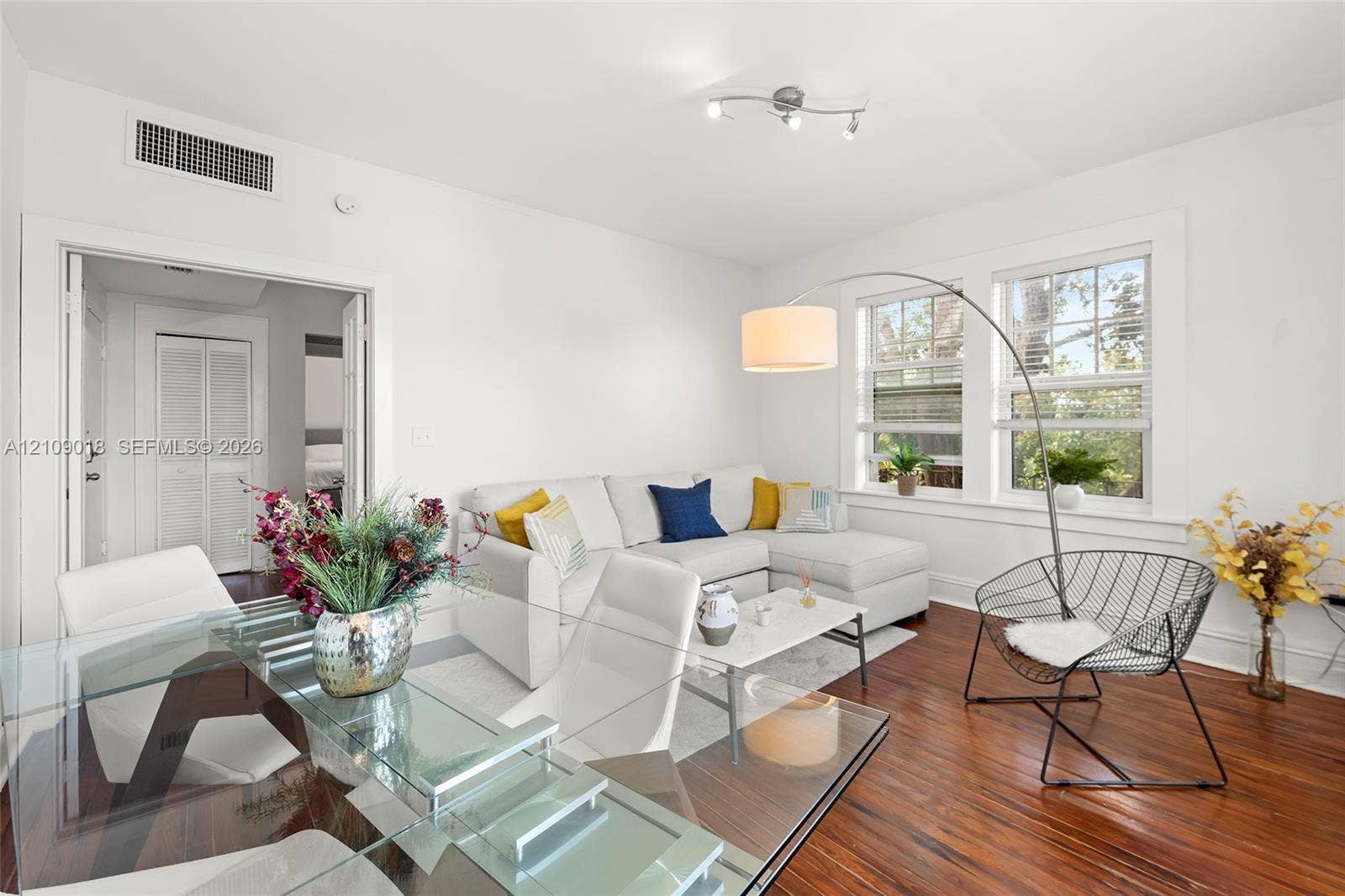 536 14th Street, #305, Miami Beach, Miami Beach, FL 33139 Living area featuring wood-finish flooring, two large windows with white trim, and a multi-directional track lighting fixture