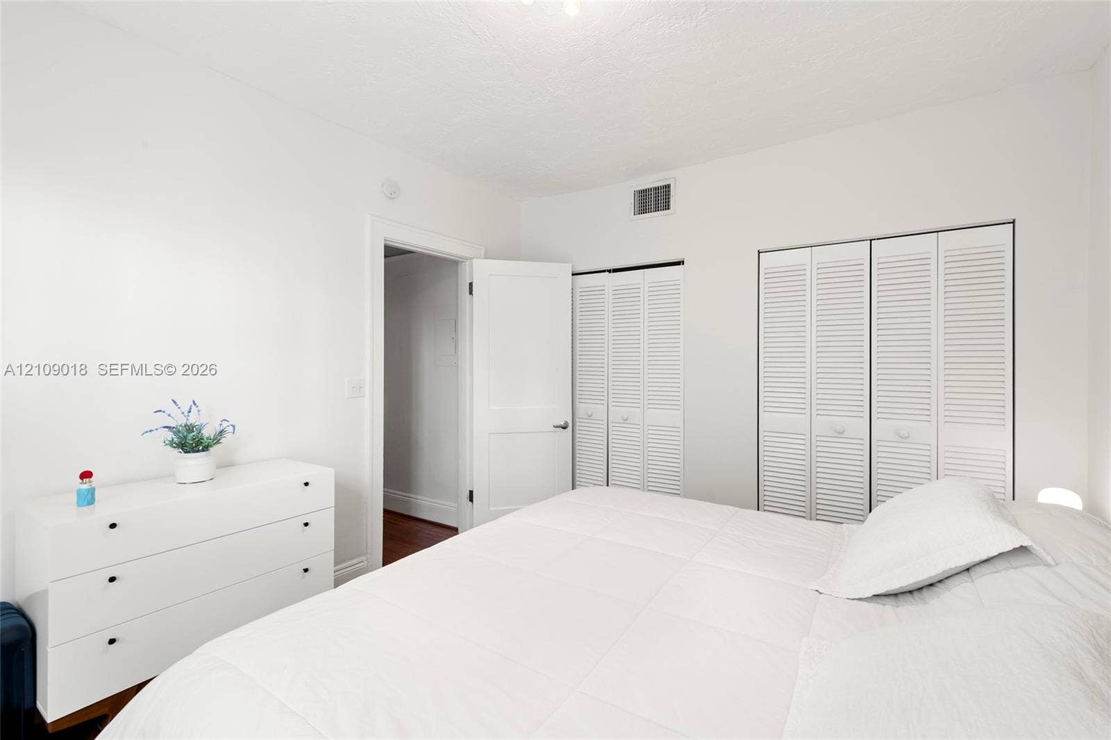 536 14th Street, #305, Miami Beach, Miami Beach, FL 33139 Neutral interior space featuring white walls, white louvered-style closet doors, and a solid-core interior door