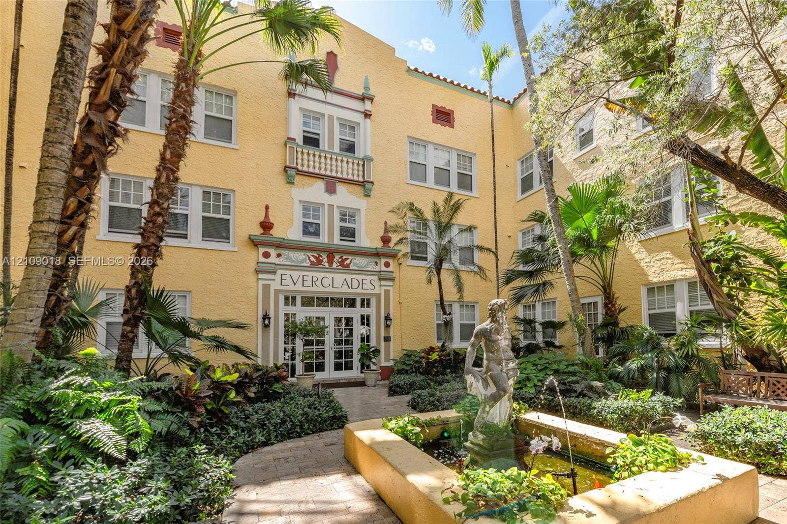 536 14th Street, #305, Miami Beach, Miami Beach, FL 33139 Mediterranean-style exterior featuring a stucco facade, decorative relief detailing, a central fountain with a sculptural centerpiece, and multi-pane windows