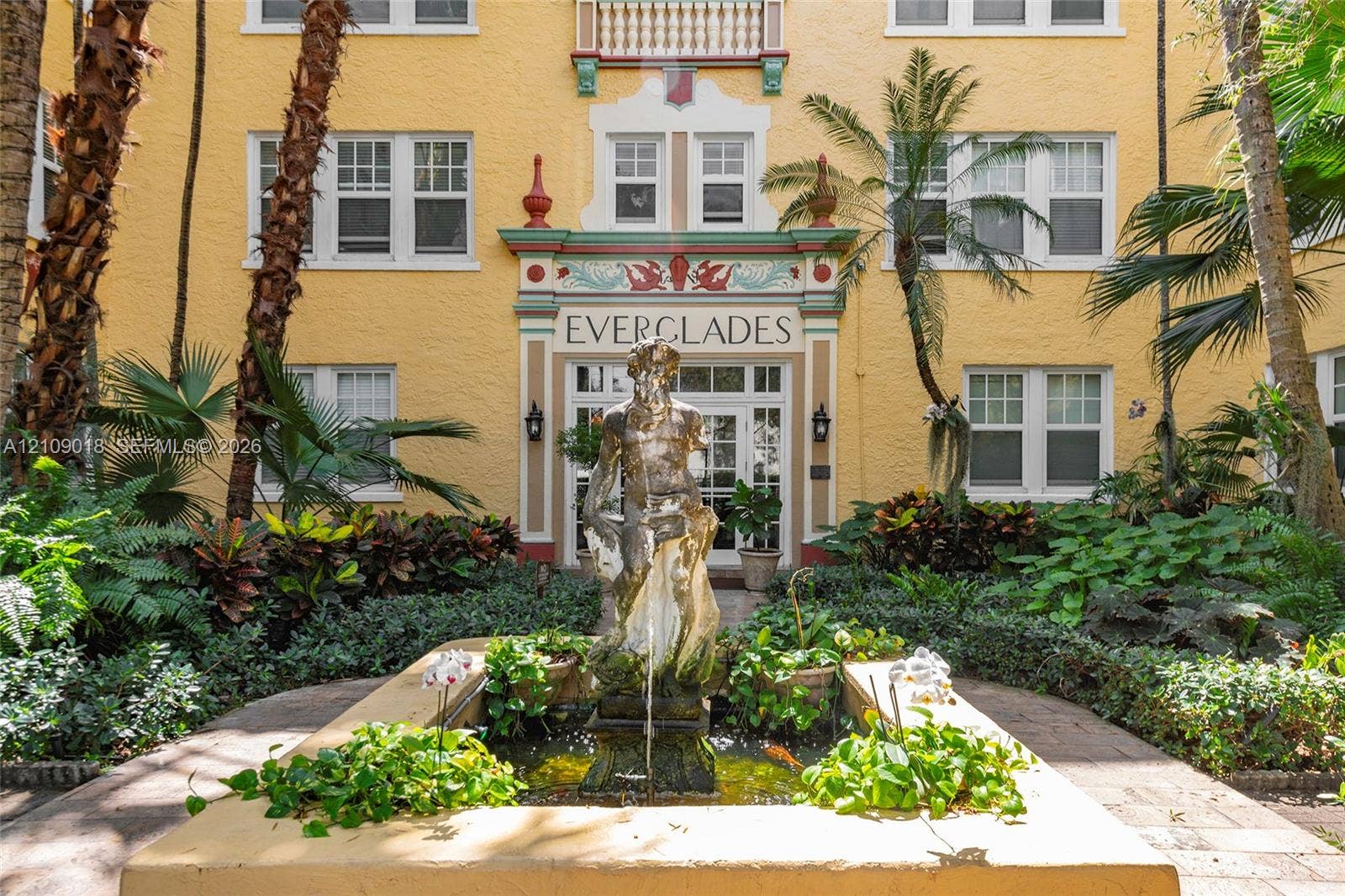 536 14th Street, #305, Miami Beach, Miami Beach, FL 33139 Mediterranean-style exterior featuring stucco facade, ornate architectural detailing, central fountain with sculptural centerpiece, and landscaped garden beds