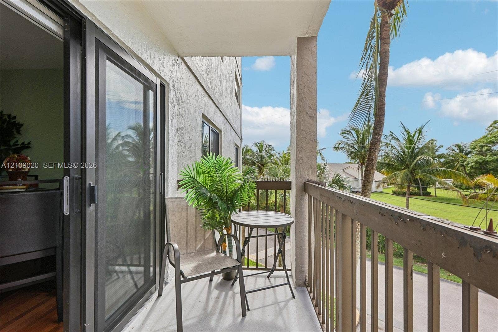 701 NW 19th Street, #300, Fort Lauderdale, FL 33311 Covered balcony featuring sliding glass doors, a concrete floor surface, and metal railing