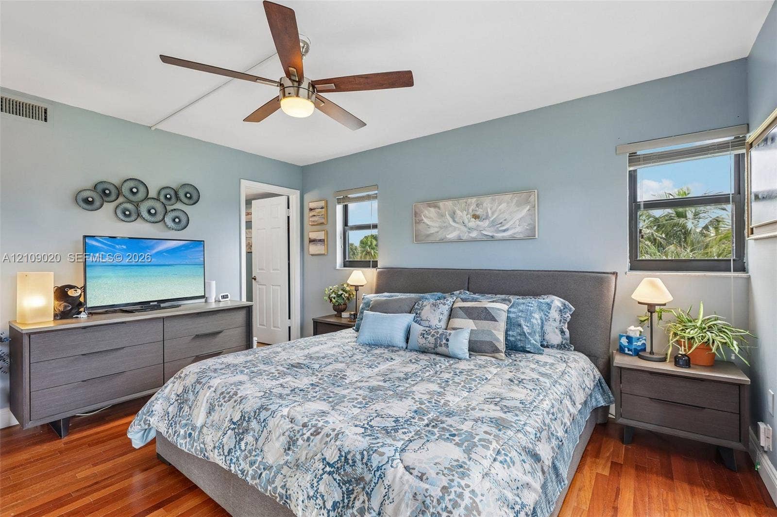 701 NW 19th Street, #300, Fort Lauderdale, FL 33311 Wood-finish flooring, multi-blade ceiling fan with integrated lighting, and dual windows