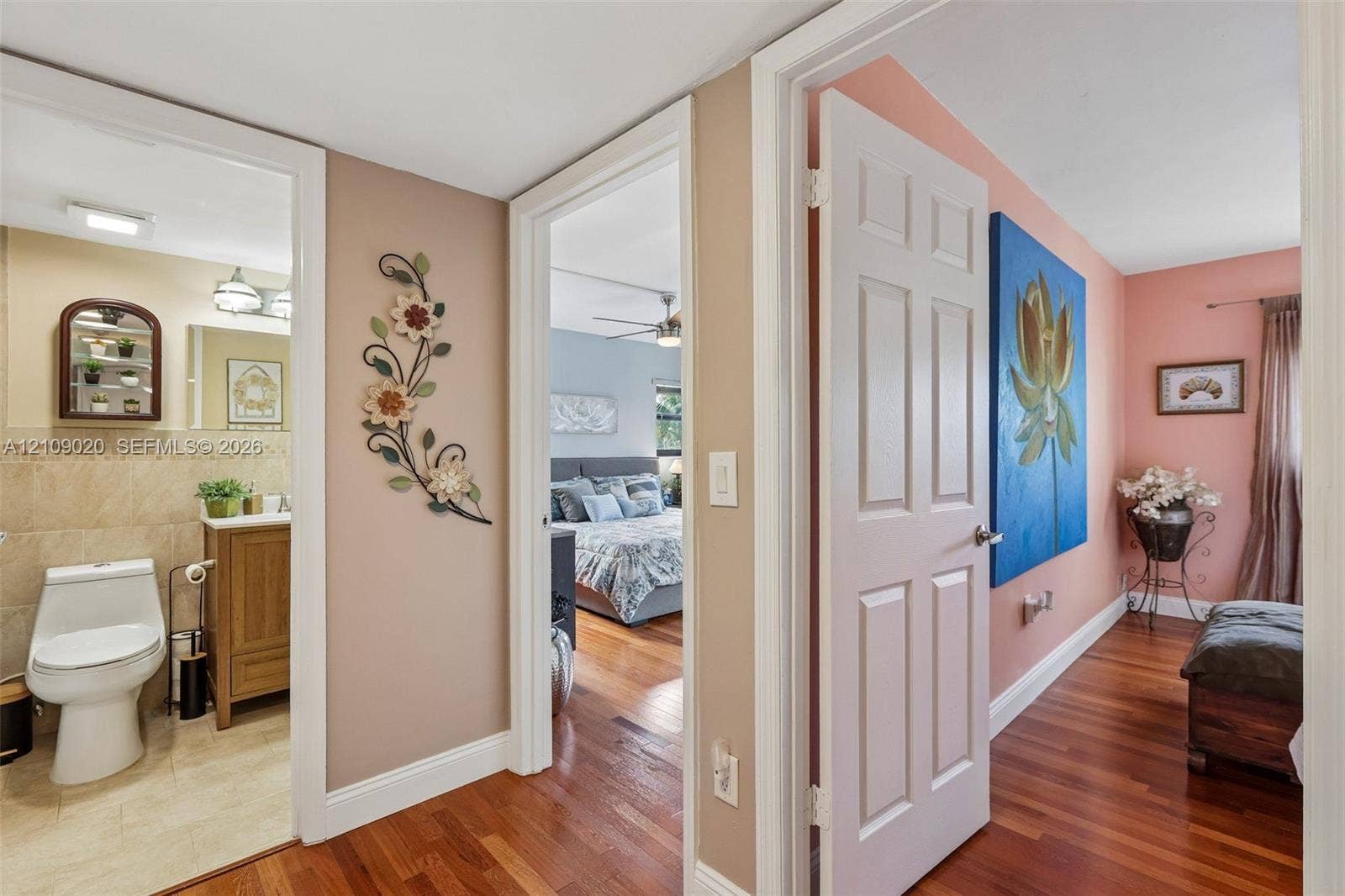 701 NW 19th Street, #300, Fort Lauderdale, FL 33311 Hallway featuring wood-finish flooring, a bathroom with a wood-finish vanity, and a six-panel interior door