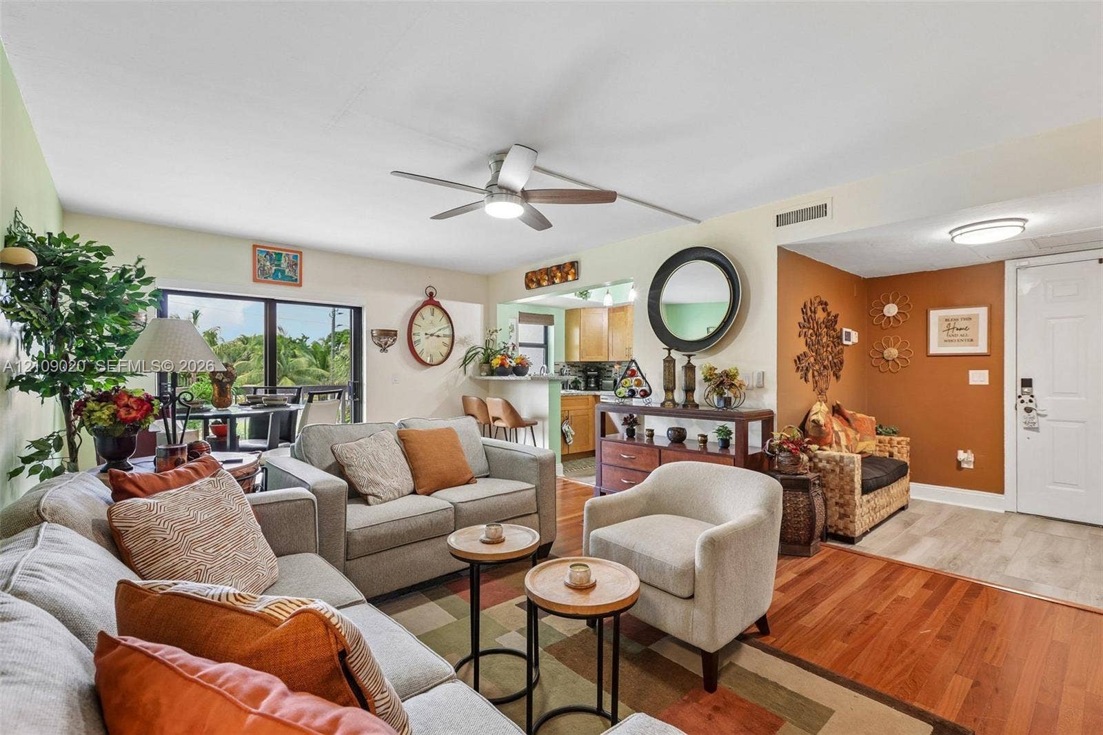 701 NW 19th Street, #300, Fort Lauderdale, FL 33311 Open-concept living area featuring wood-finish flooring, a ceiling-mounted light fixture with fan, and a neutral color palette