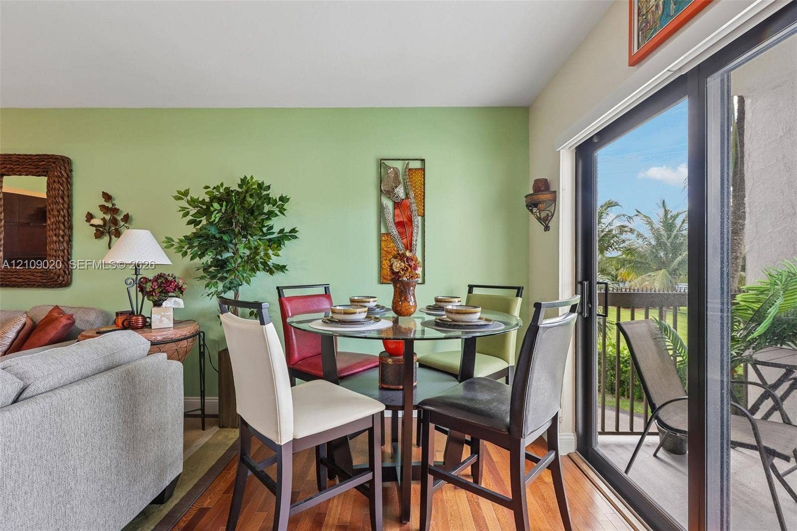 701 NW 19th Street, #300, Fort Lauderdale, FL 33311 Wood-finish flooring and floor-to-ceiling sliding glass doors opening to a balcony
