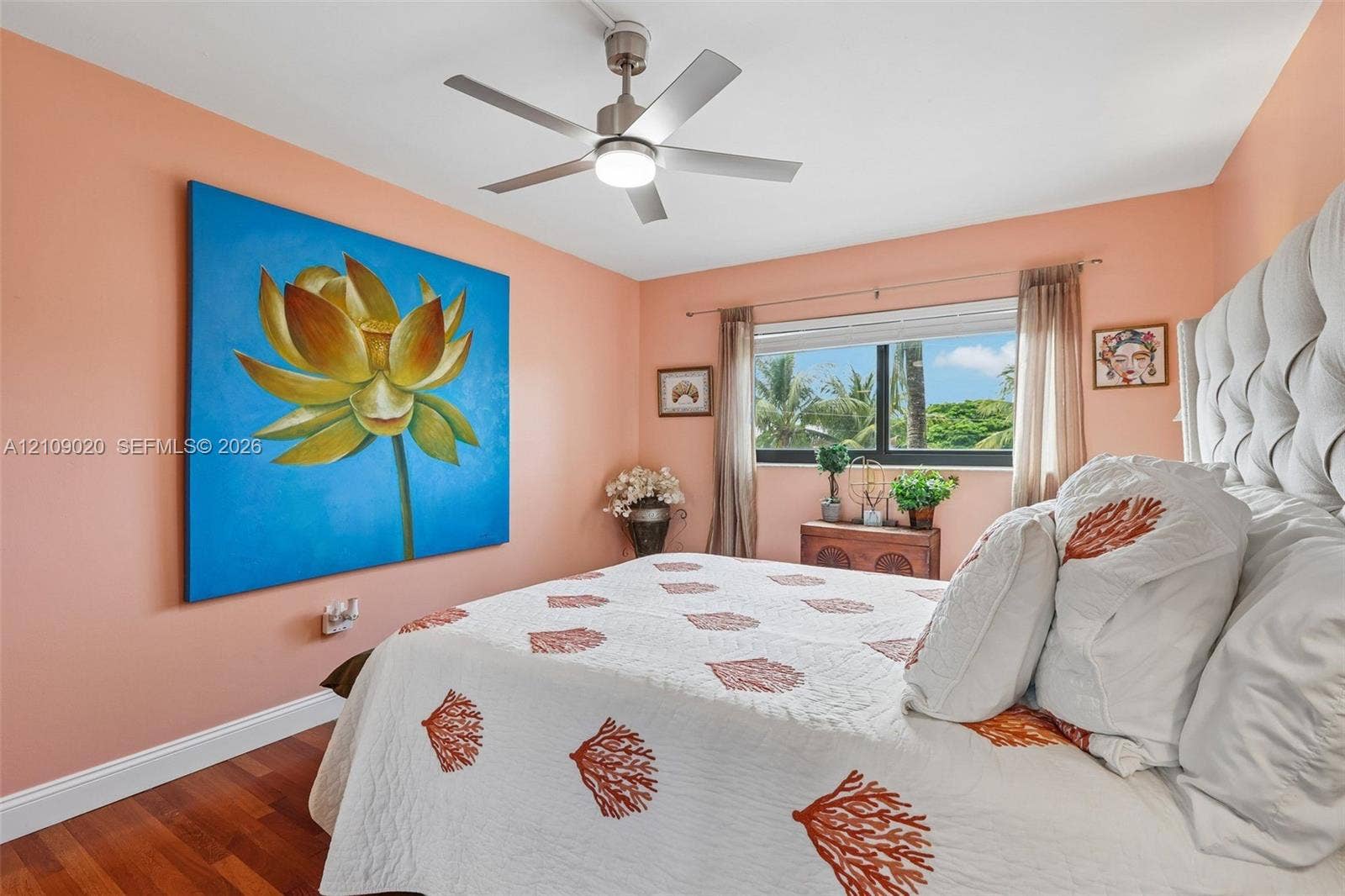 701 NW 19th Street, #300, Fort Lauderdale, FL 33311 Wood-finish flooring, brushed metal ceiling fan with integrated lighting, and a horizontal window with exterior tropical greenery