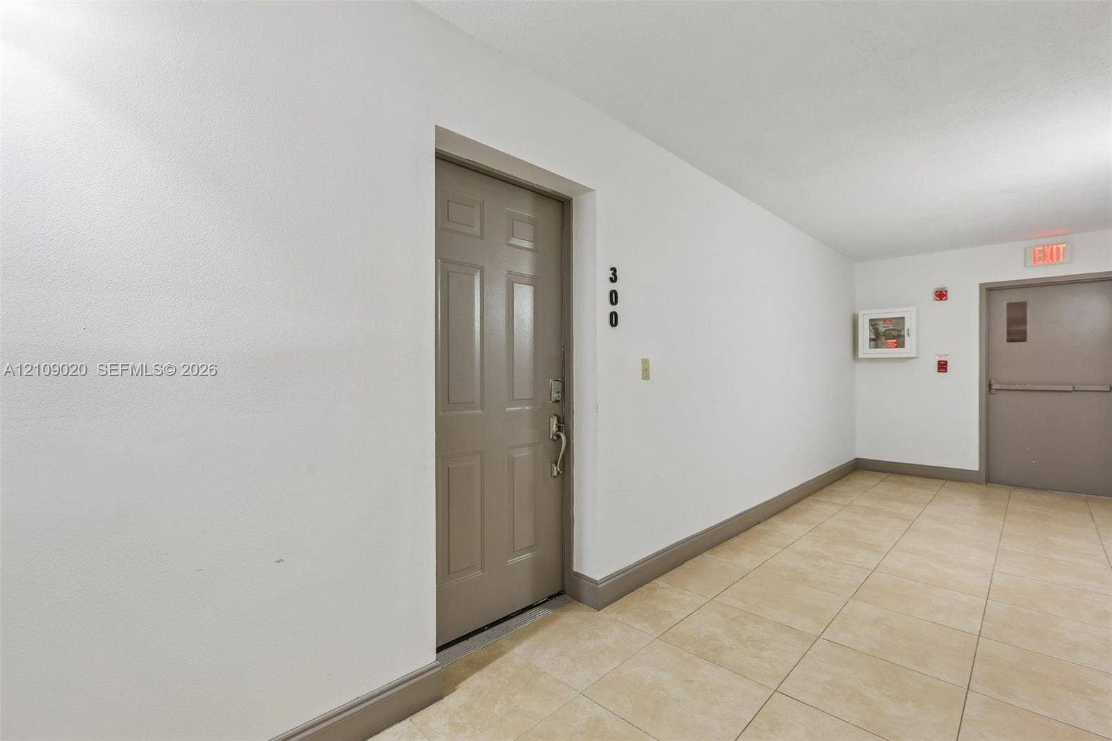 701 NW 19th Street, #300, Fort Lauderdale, FL 33311 Neutral-toned entry door with six-panel design and ceramic tile flooring throughout