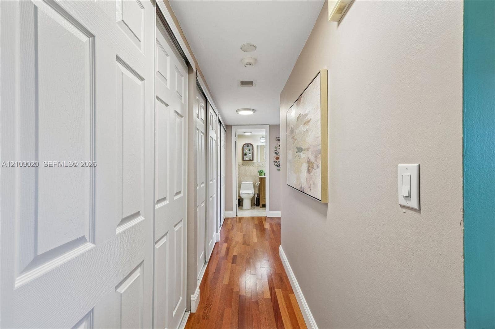 701 NW 19th Street, #300, Fort Lauderdale, FL 33311 Hallway featuring wood-finish flooring, dual sliding-panel closet doors, and recessed lighting
