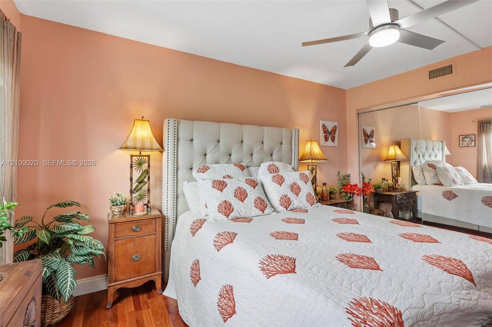 701 NW 19th Street, #300, Fort Lauderdale, FL 33311 Bedroom featuring wood-finish flooring, a ceiling fan with integrated lighting, and mirrored sliding closet doors