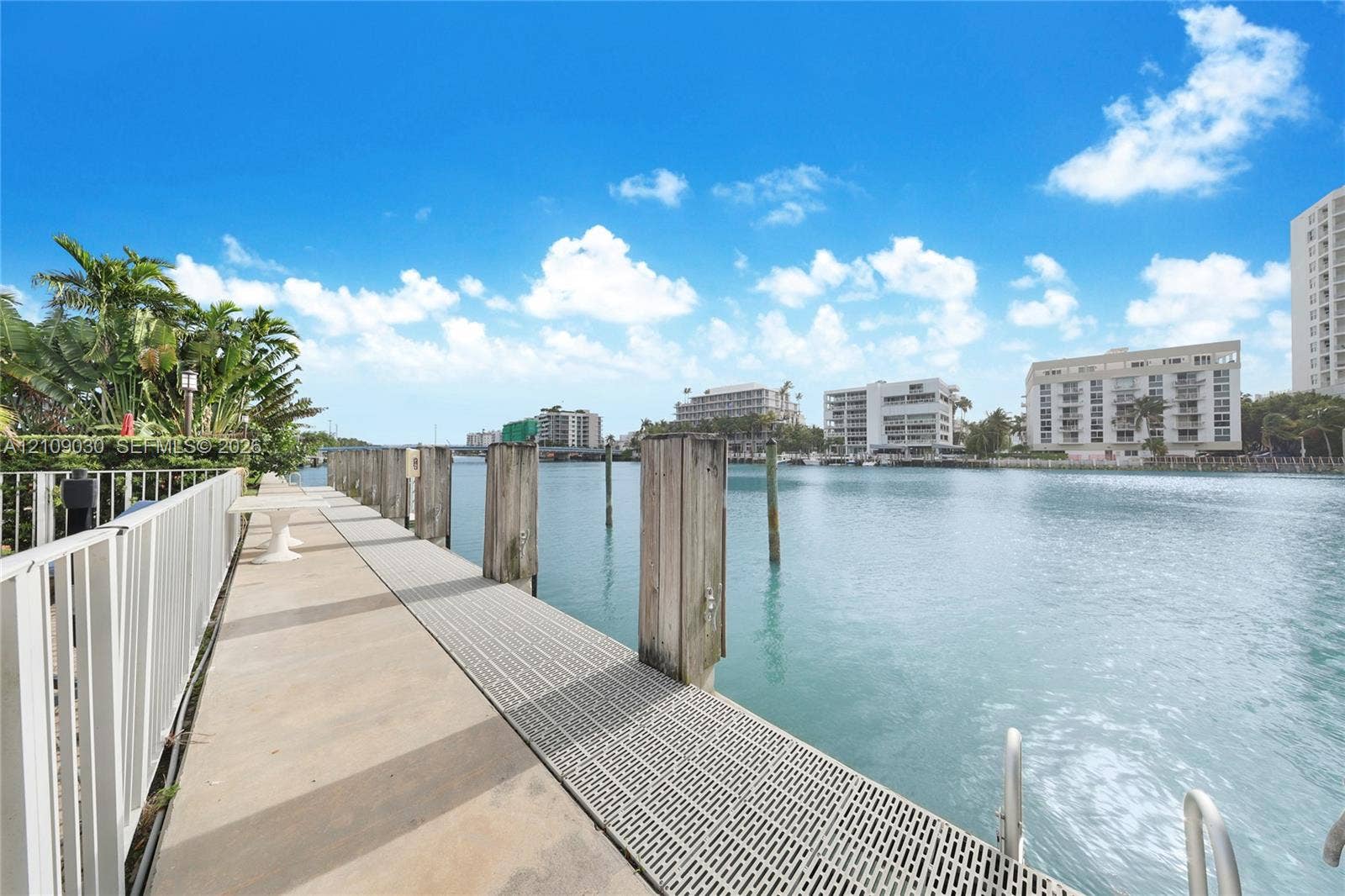 Waterfront dock featuring concrete decking, metal grate paneling, and wood pilings