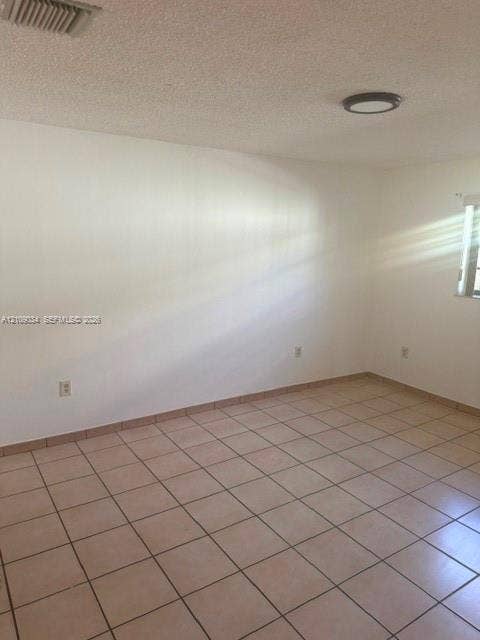 Interior space featuring neutral wall tones, ceramic tile flooring, and a flush-mount ceiling light fixture