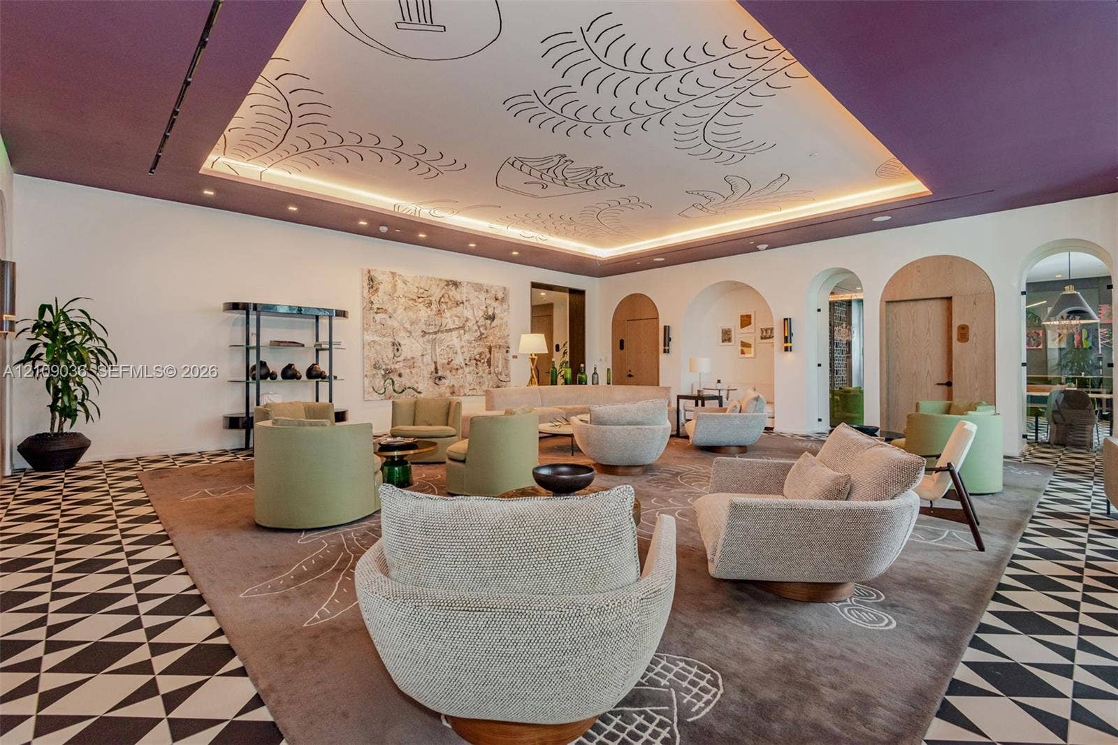 Geometric patterned tile flooring, coffered ceiling with hand-painted artistic detail, recessed perimeter lighting, and arched doorways with wood-panel accents