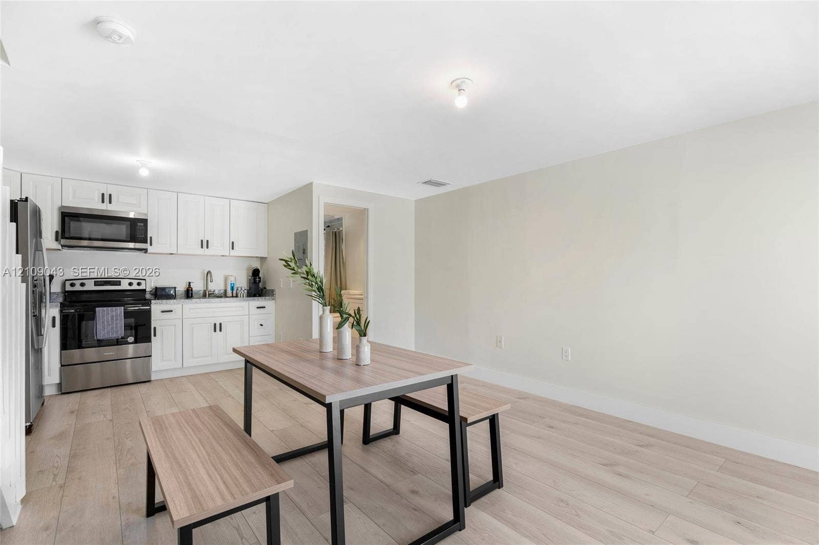 605 SW 17th Street, #1-3, Fort Lauderdale, Fort Lauderdale, FL 33315 Kitchen featuring white shaker-style cabinetry, stainless steel appliances, and wood-finish flooring