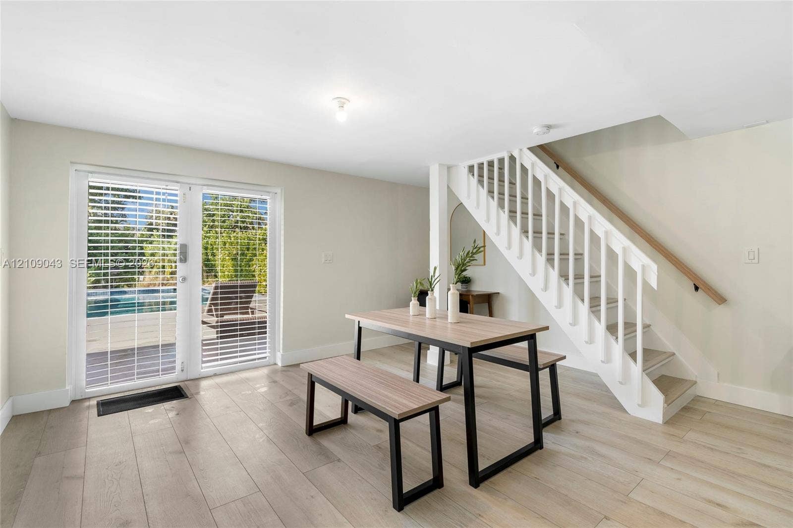605 SW 17th Street, #1-3, Fort Lauderdale, Fort Lauderdale, FL 33315 Wood-finish flooring, white staircase with handrail, and full-glass double doors