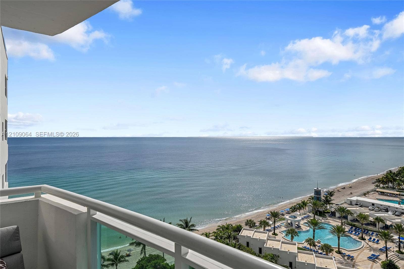 Private balcony featuring a metal railing and glass paneling with an expanse of ocean scenery