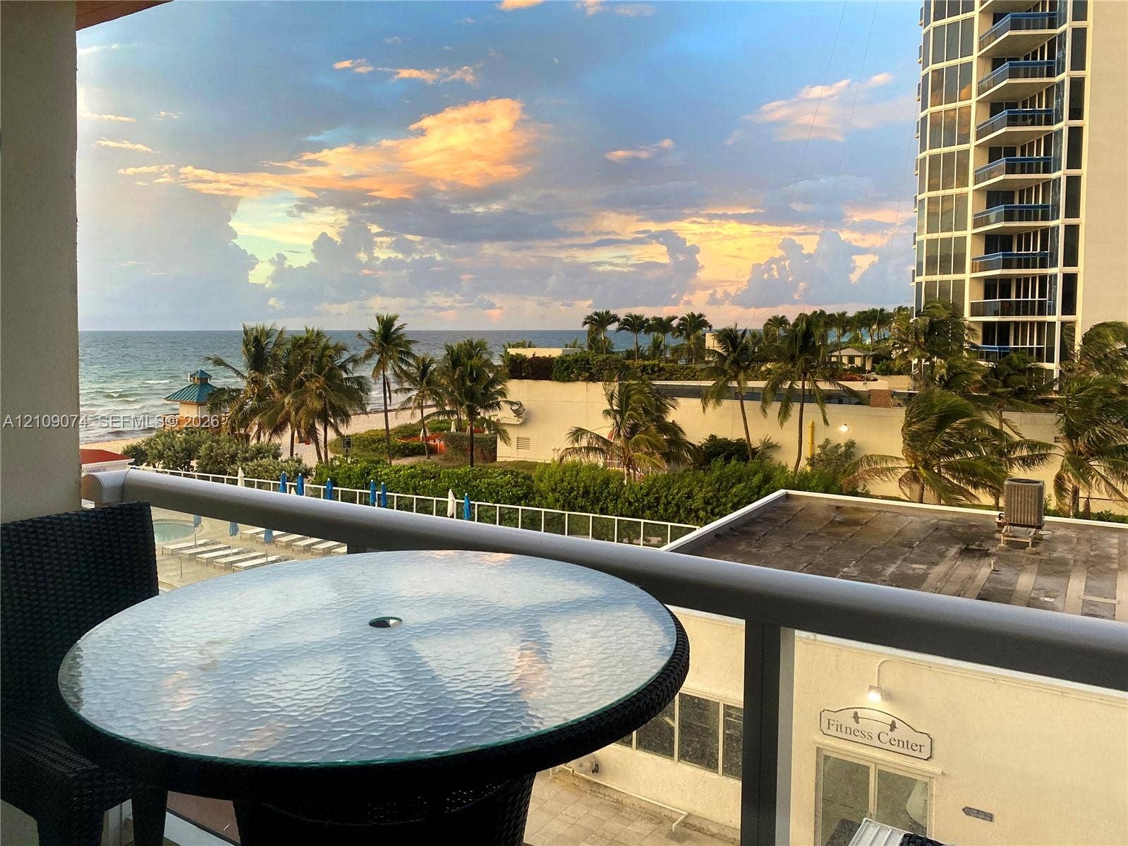 Private balcony featuring glass railings and panoramic ocean scenery