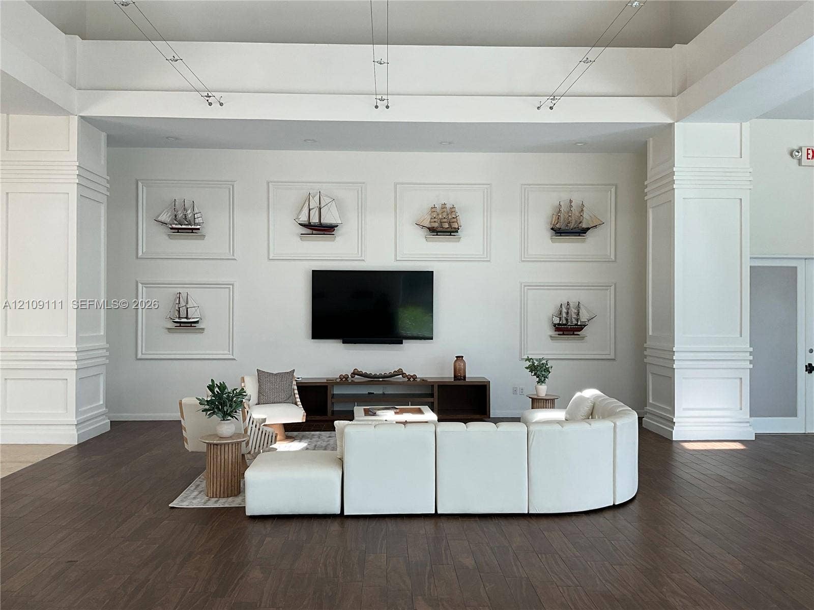 3370 Hidden Bay Drive, #801, Aventura, FL 33180 Tray ceiling with recessed lighting, prominent architectural columns with millwork, and dark wood-finish flooring