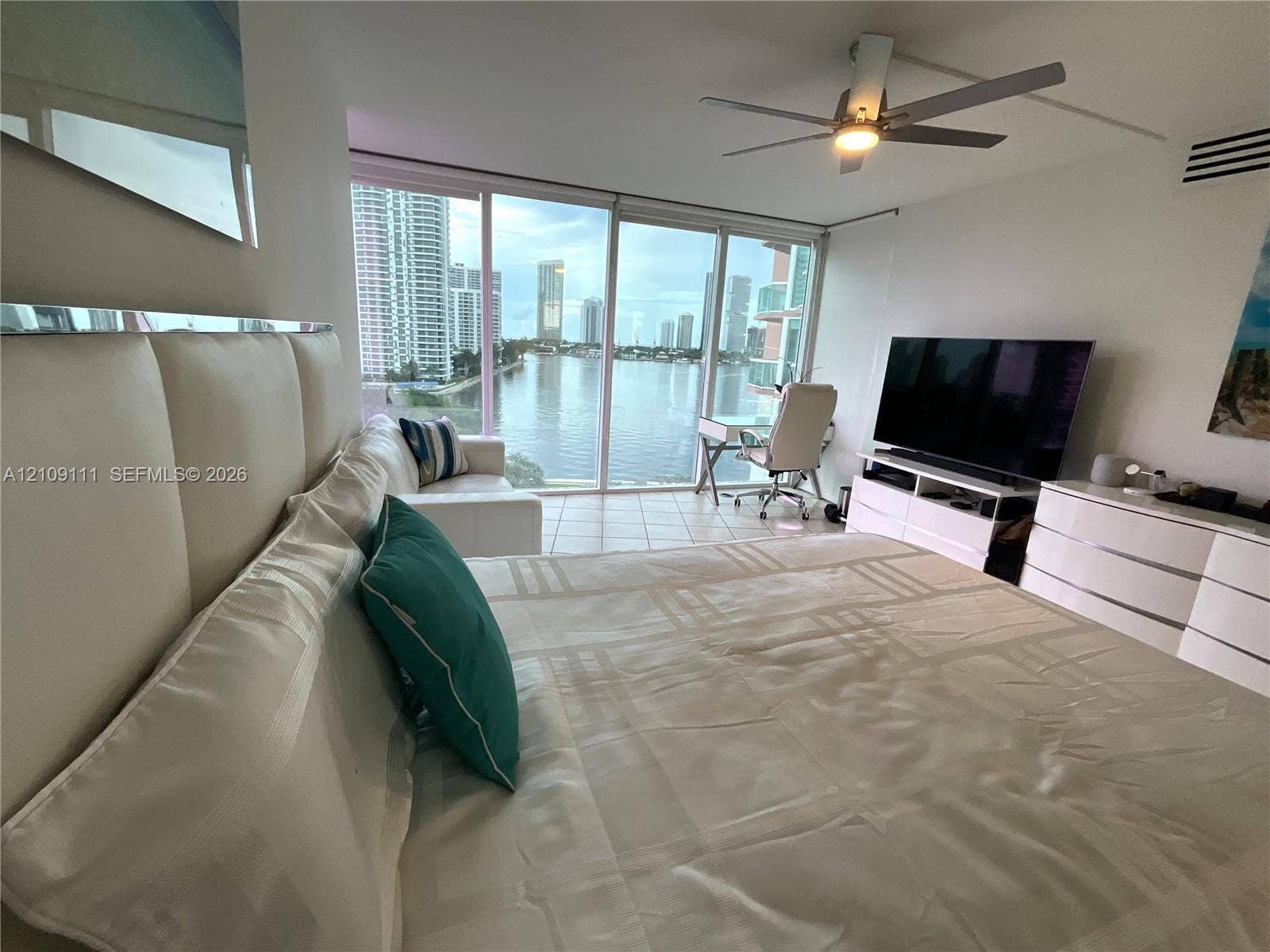 3370 Hidden Bay Drive, #801, Aventura, FL 33180 Floor-to-ceiling windows featuring urban water and skyline scenery, tile flooring, and a ceiling fan