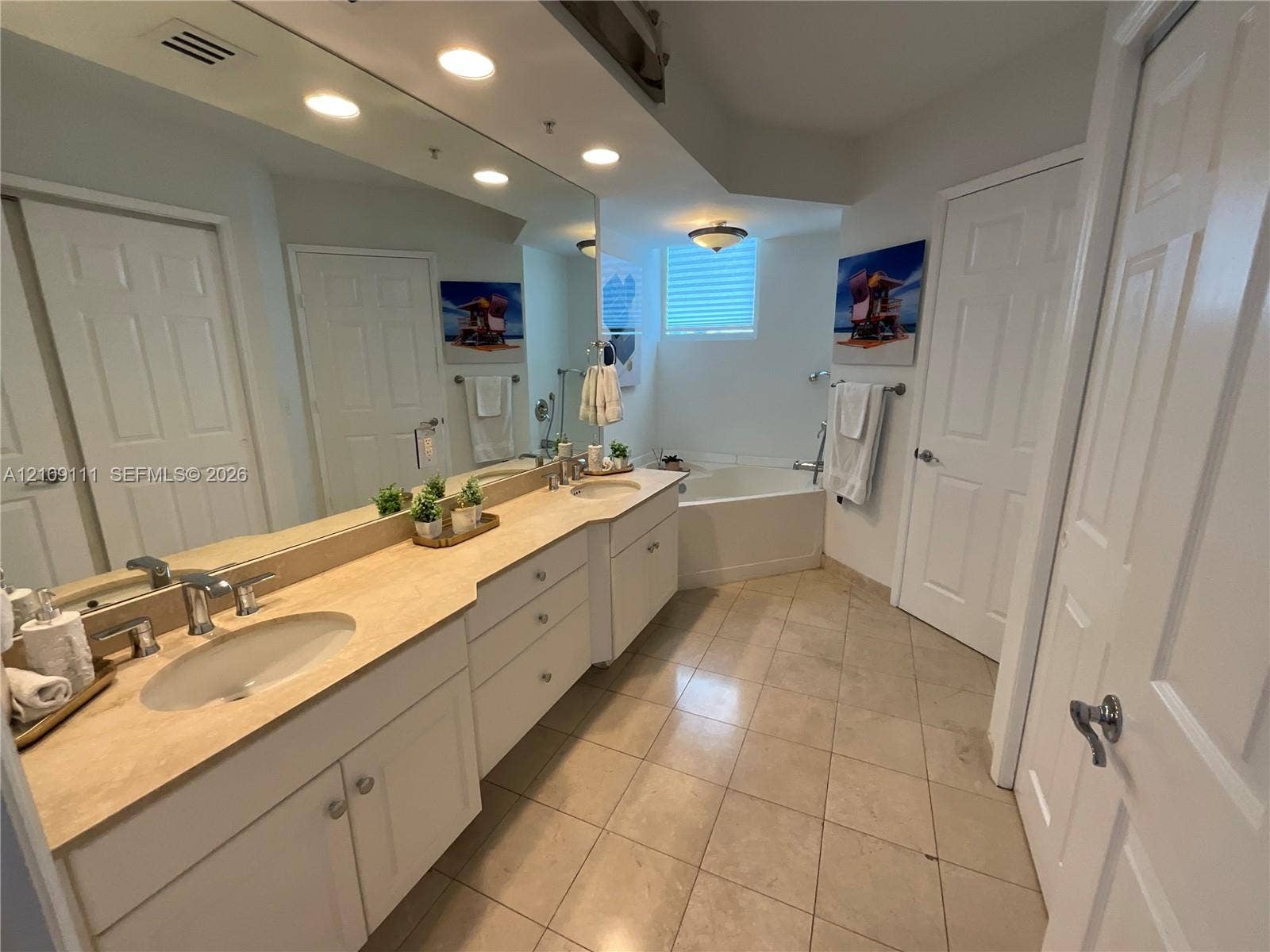3370 Hidden Bay Drive, #801, Aventura, FL 33180 Dual-sink vanity with stone countertop, recessed lighting, tile flooring, and integrated soaking tub