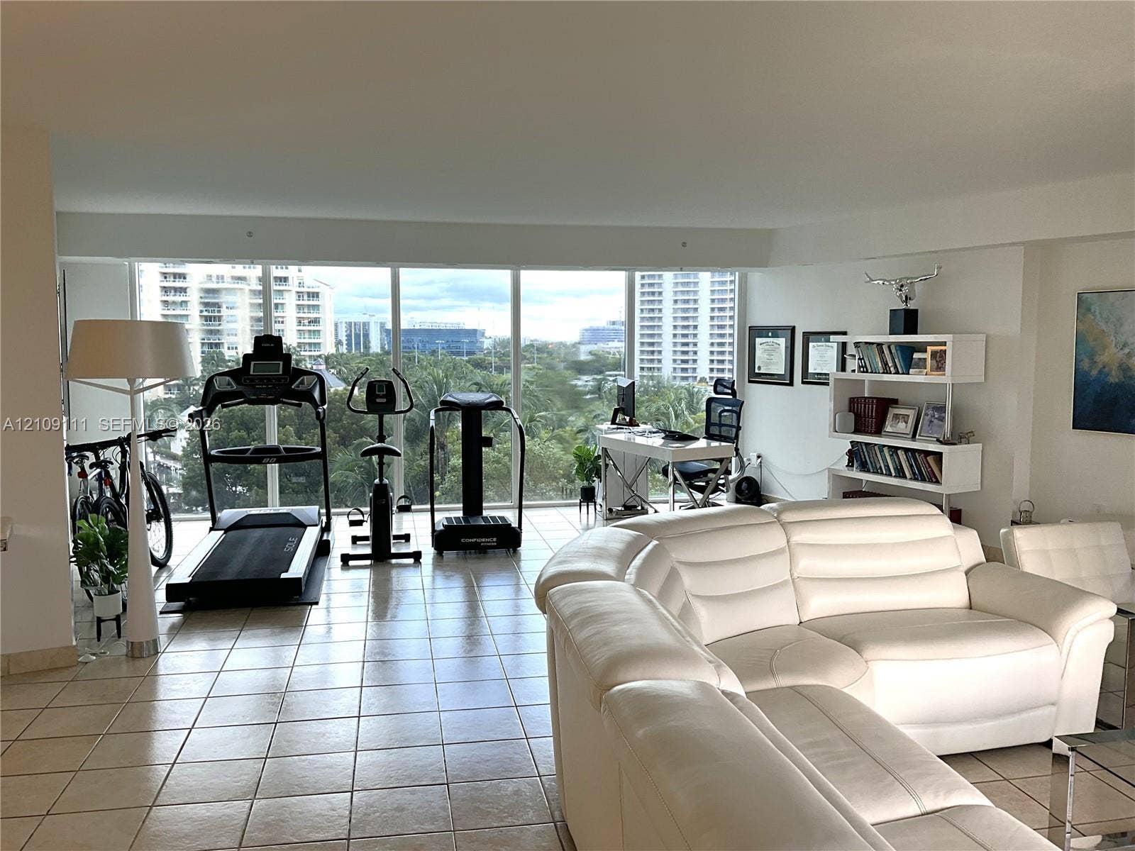 3370 Hidden Bay Drive, #801, Aventura, FL 33180 Open-concept interior featuring large-format ceramic tile flooring and expansive floor-to-ceiling windows