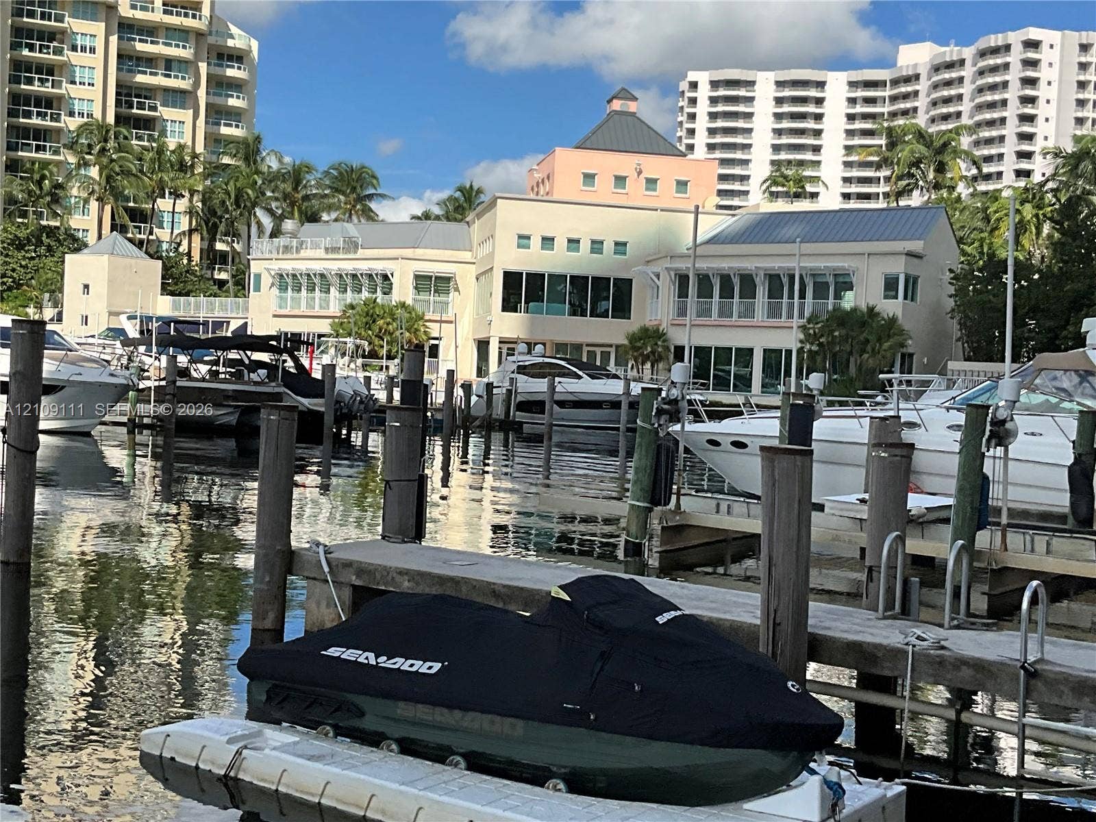 3370 Hidden Bay Drive, #801, Aventura, FL 33180 Waterfront property featuring a private deep-water dock, multiple boat slips, and piling supports
