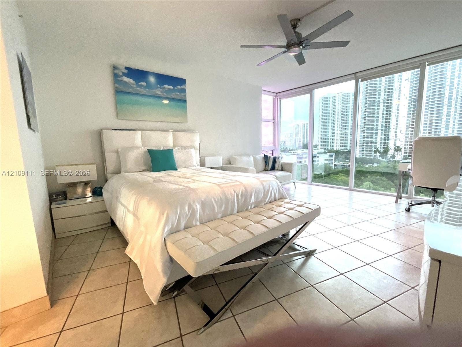 3370 Hidden Bay Drive, #801, Aventura, FL 33180 Floor-to-ceiling glass windows, ceramic tile flooring, and a ceiling-mounted light fixture with fan