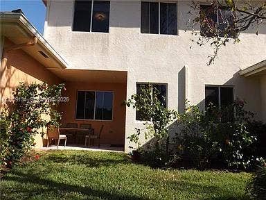 2529 SW Stockbridge Square SW, Vero Beach, FL 32962 Stucco exterior featuring a covered patio, dual-tone facade, and multiple windows