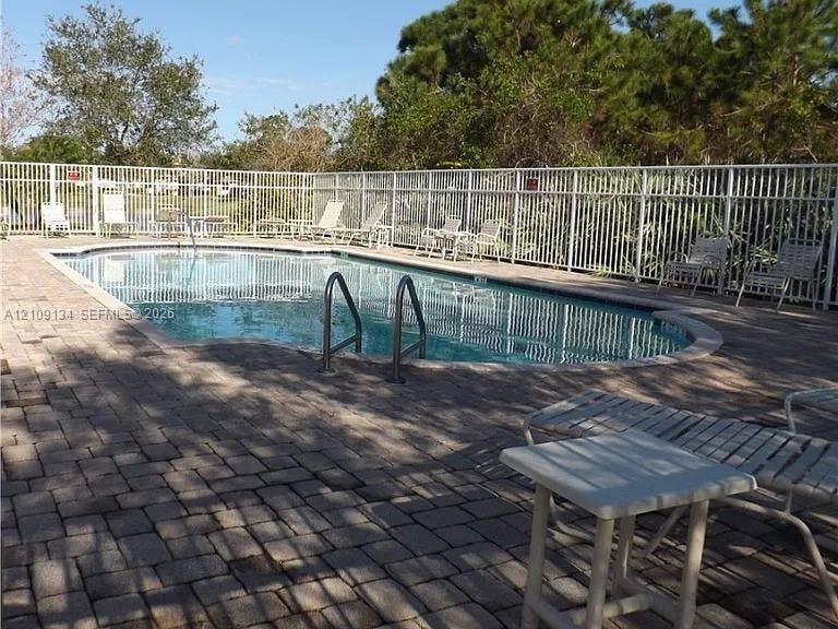 2529 SW Stockbridge Square SW, Vero Beach, FL 32962 Swimming pool featuring brick paver decking and perimeter aluminum fencing