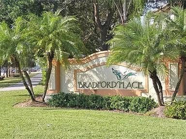 2529 SW Stockbridge Square SW, Vero Beach, FL 32962 Stucco masonry monument sign featuring dimensional lettering, decorative trim, and mature landscaping including palm trees