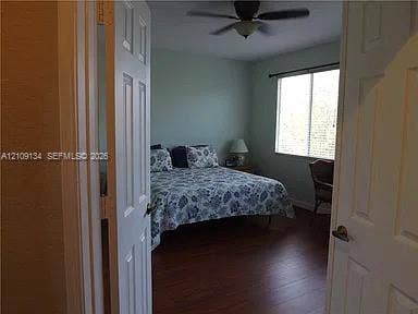 2529 SW Stockbridge Square SW, Vero Beach, FL 32962 Wood-finish flooring, double-panel interior entry doors, and a ceiling fan with integrated light fixture