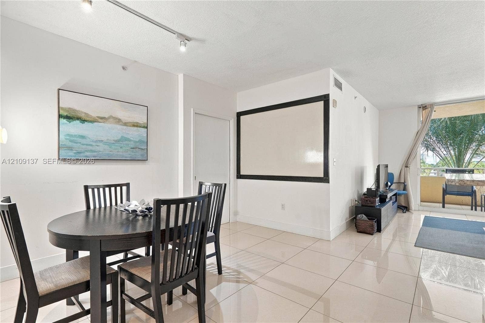 18800 NE 29th Avenue, #411, Aventura, FL 33180 Neutral-toned tile flooring, track lighting, and a private balcony featuring an exterior railing