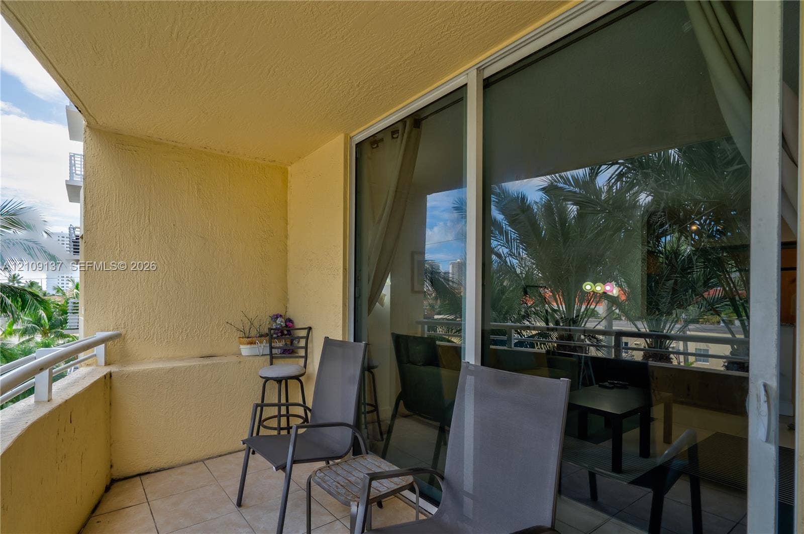 18800 NE 29th Avenue, #411, Aventura, FL 33180 Private balcony featuring tiled flooring, textured wall surfaces, and a metal railing